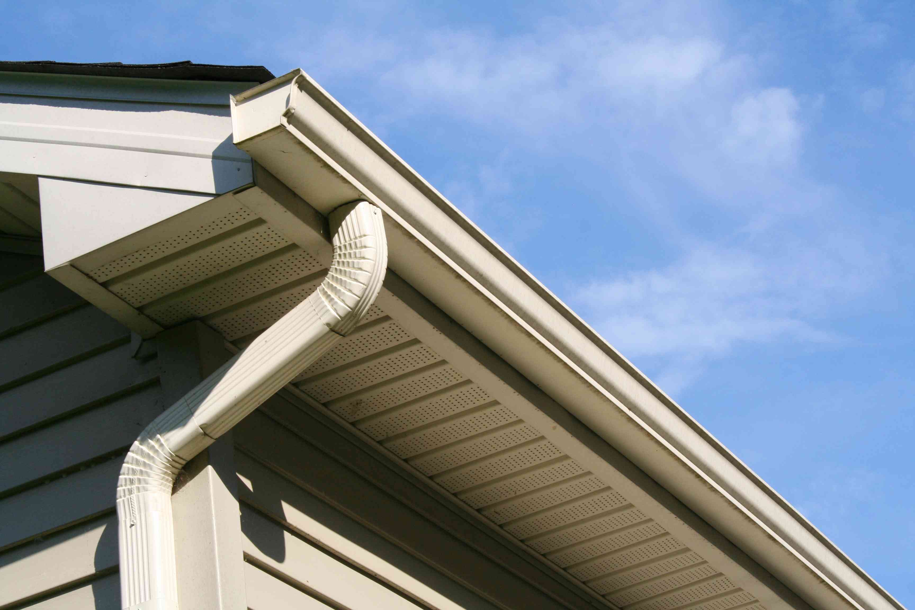 Gutter cleaning service in Tampa on a two-story home with visible gutter and roofline access